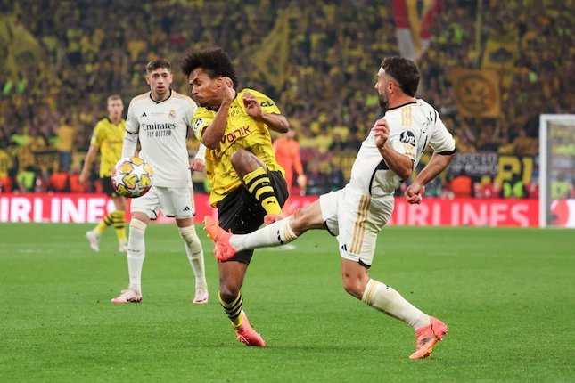 Duel Karim Adeyemi dan Dani Carvajal dalam laga final Liga Champions antara Borussia Dortmund vs Real Madrid, Minggu (2/6/2024). (c) AP Photo/Ian Walton